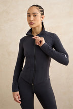 Black zip up sculpting jacket close up women's activewear tennis yoga pilates